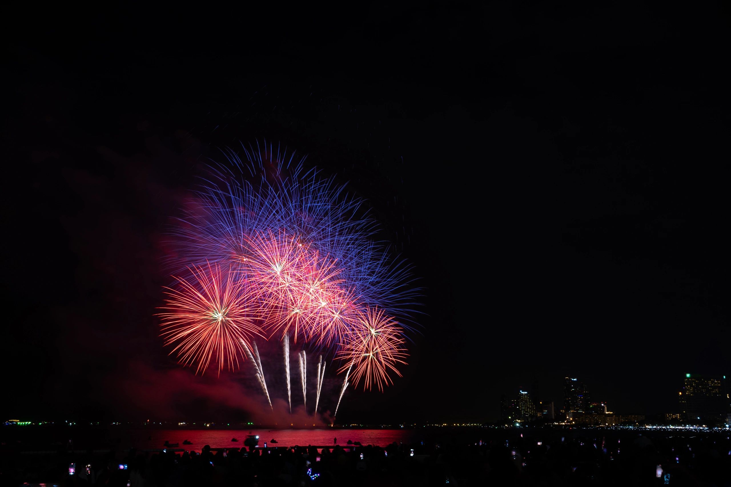 Fireworks bursting above a nighttime celebration