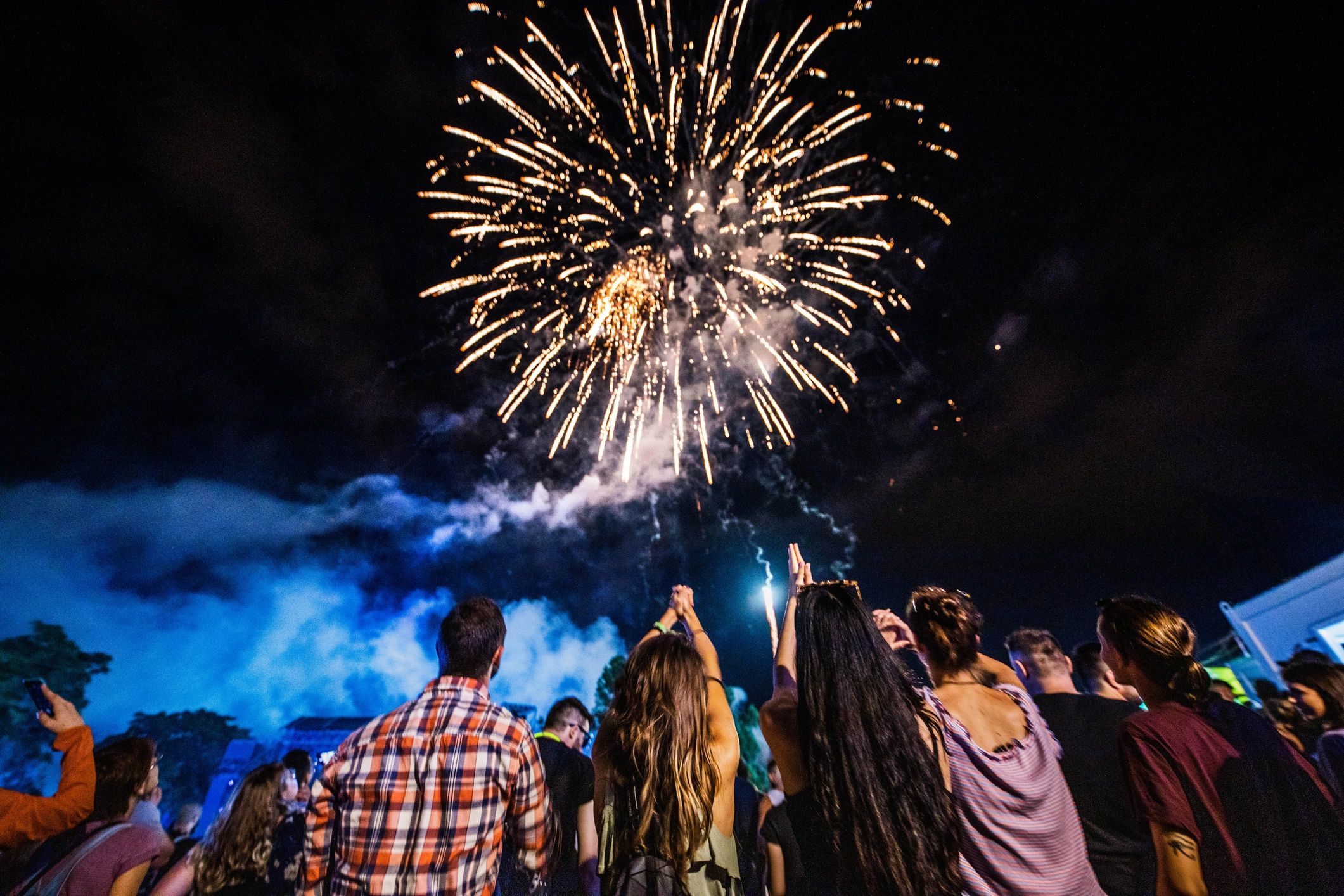 Crowd watching a fireworks display at night